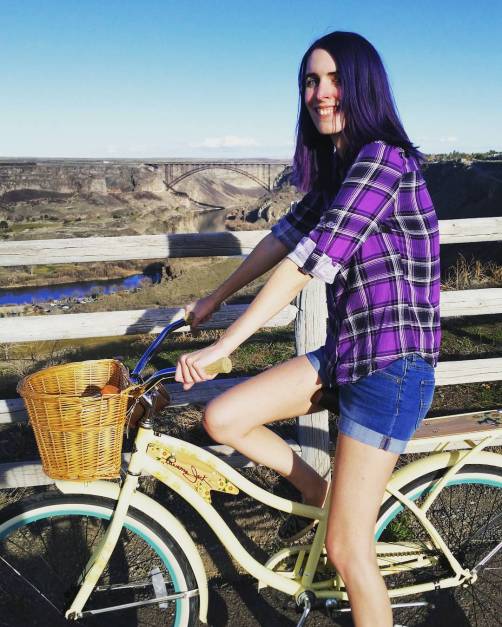 girl with purple hair on bicycle